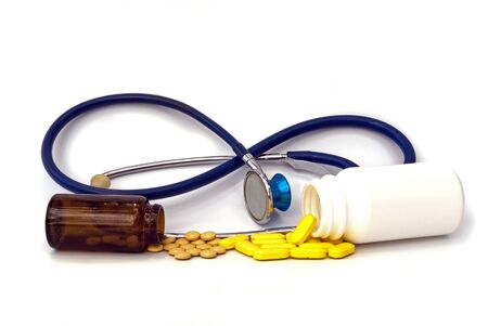 stethoscope with pill against white backgroundの写真素材