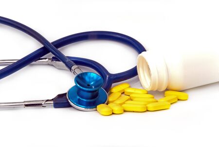 stethoscope with pill against white backgroundの写真素材