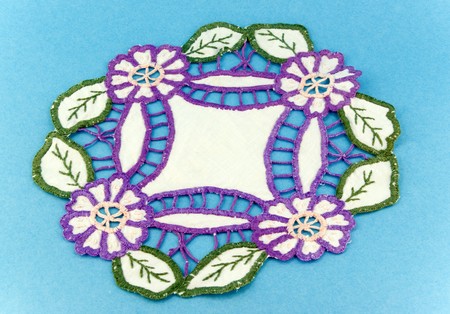 embroidered napkin on blue background