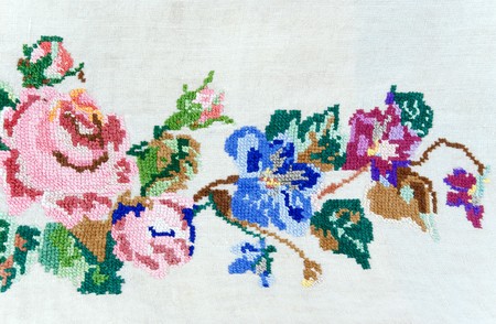 flowers embroidered with cross-stitch on linenの写真素材