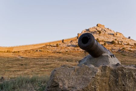 medieval gun against the fortressの写真素材