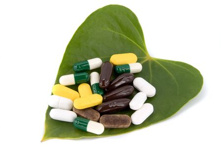 pills in green leaf on white backgroundの写真素材