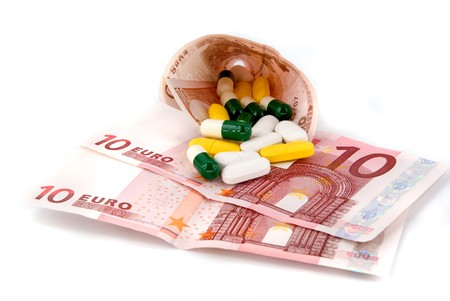 scattered pills on moneyの写真素材