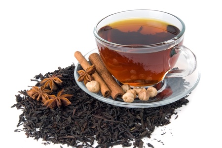 cup of tea and spice on heap of tea leafの写真素材