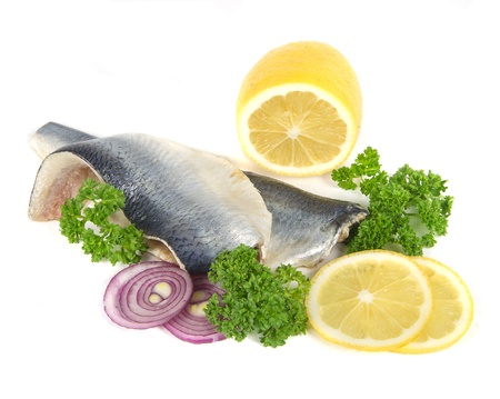  herring with herbs and lemon on white backgroundの写真素材