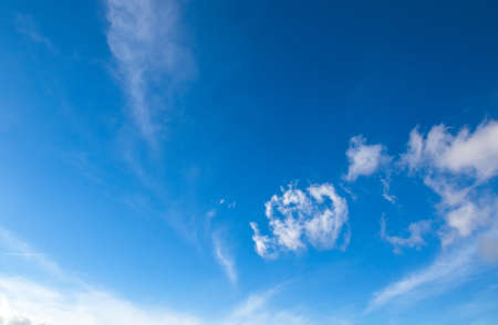 white clouds against blue autumnal sky