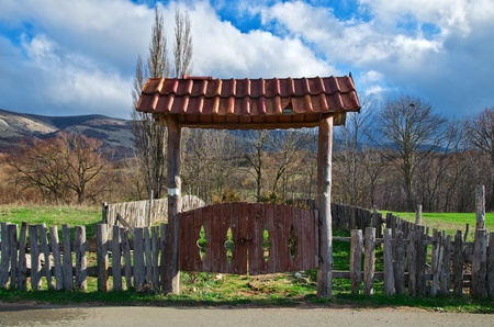 old rural gate into farm against skyの写真素材
