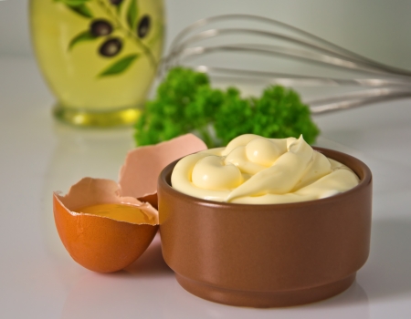 mayonnaise and its ingredients on the tableの写真素材