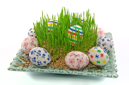 Easter eggs and wheat grass on a plate