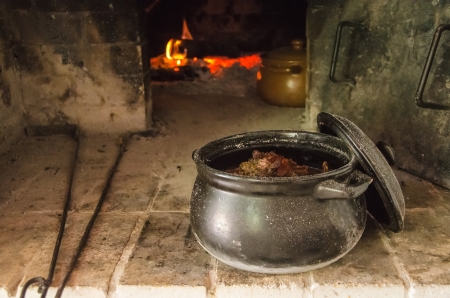 stew meat in ceramic pot cooked at stoveの写真素材