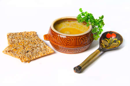 puree soup in ceramic bowl with wooden spoonの写真素材