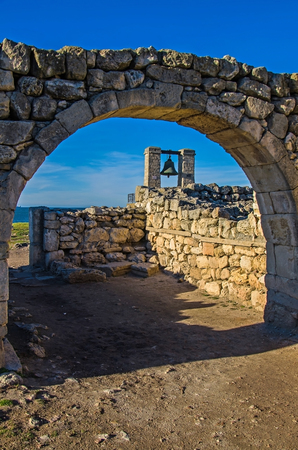 ancient bell against ruins in memorial Chersoneseの写真素材