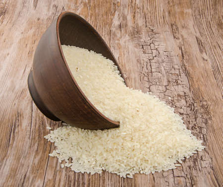 ceramic cup with rice on the old plank tableの写真素材