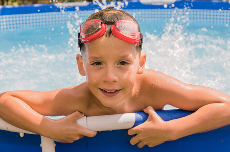 happy boy in the swimming poolの写真素材