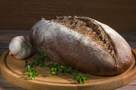 bread with spice on cutting board in dark