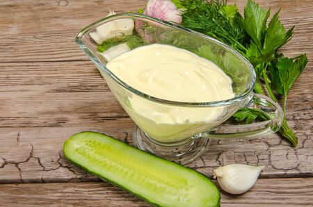 spring vegetables with mayonnaise on wooden tableの写真素材