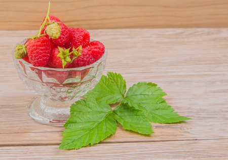 raspberry in glass bowl on table