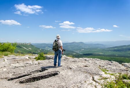 man on top of mountain with backpackの写真素材