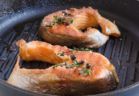 Grilled trout steak with spices on grill panの写真素材