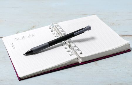 Open notebook on wooden table with pencil. The inscription in the notebook "To do list"の写真素材