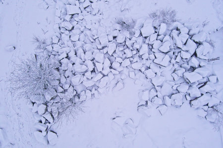 Aerial view of pile of large stones and trees covered with snow in winter, Kuhakoski, NurmijÃ¤rvi,...