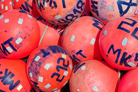 Closeup of old plastic buoys for crab cages on the ground.の写真素材
