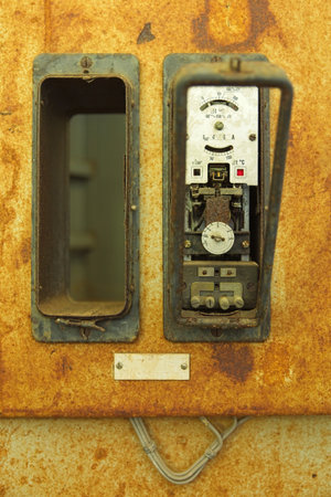 Old antique electrical device on wall.の写真素材