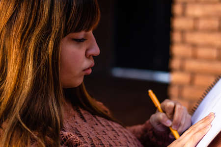 Beautiful girl drawing in peace in her backyard.の写真素材