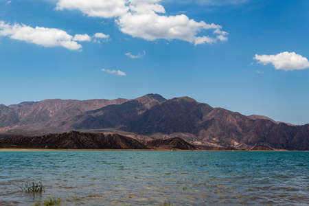 Wonderful Potrerillos Mountains in front of lake and clouds.の写真素材