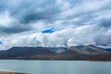 Landscape view of the lake and mountains under the cloudy sky.の写真素材