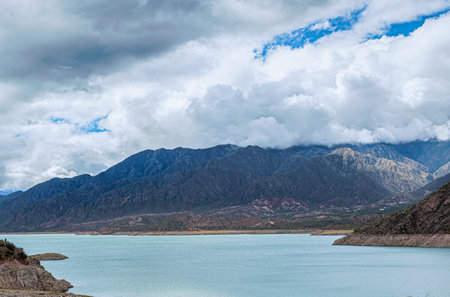 Beautiful view of the lake and mountains under the cloudy sky.の写真素材
