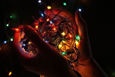 Christmas lights holding in handsの写真素材