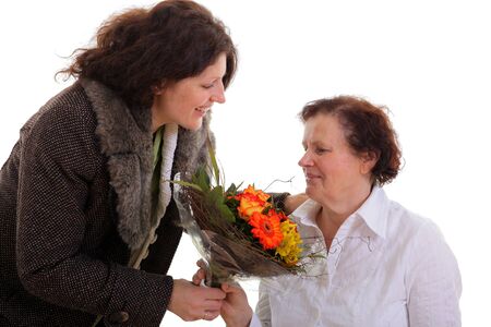 Daugther giving flowers to her mother for mother s day  の写真素材