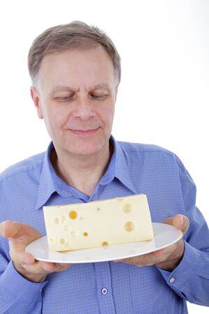 Handsome man holding cheese on a plate の写真素材