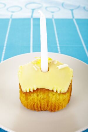 Lemon birthday cake with one candle の写真素材