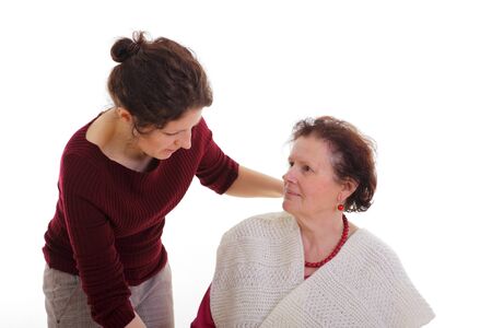 Daugther helping a senior woman at home の写真素材