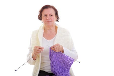 Senior woman knitting a scarf の写真素材