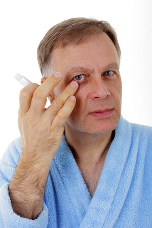 Handsome man in blue bathrobe with lipstick の写真素材