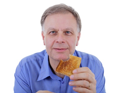 Mature man holding toast and looking at you の写真素材