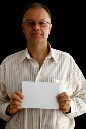 Man holding a blank white board  Black background の写真素材