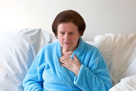 Sick woman cough in bedの写真素材