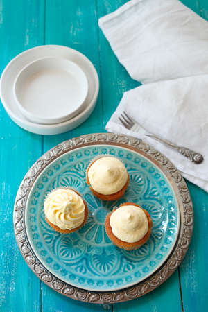 Three delicious cupcakes on a plate.の写真素材