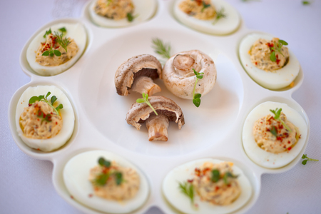 Hard-boiled eggs cut in half and filled with  champignons.の写真素材