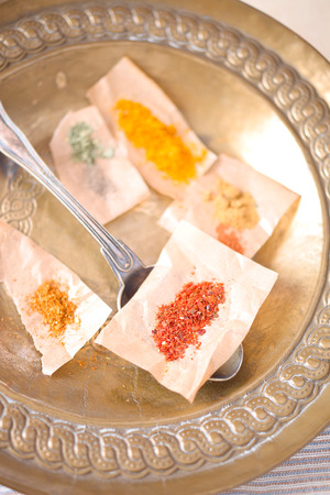 Spices: chili, cumin, pepper, curry on a plate.の写真素材