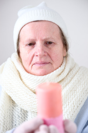 Senior woman with candleの写真素材