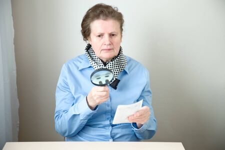 Elderly  woman with magnifierの写真素材
