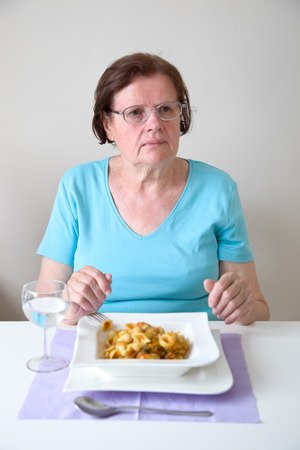 Mature woman eating lunchの写真素材