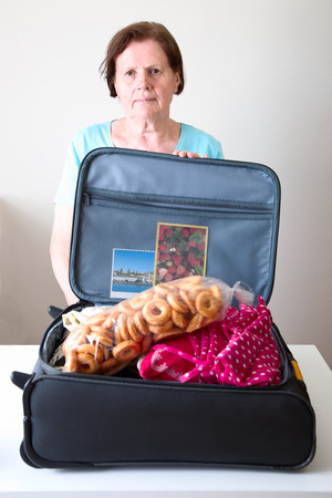 Woman with a open suitcaseの写真素材