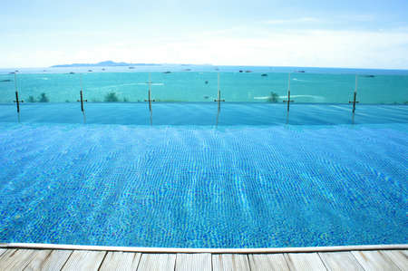 relax at swimming pool with blue sky and  island viewの写真素材