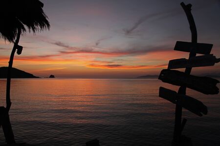 romantic beautiful sunset in the evening shadow sign wood relax beach at Koh Mak island Trat Thailandの写真素材